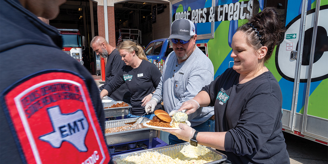 Ashtin Pizarro and other CoServ Employees use the Snackin' Wagon to feed first responders.  Photo by BRIAN ELLEDGE