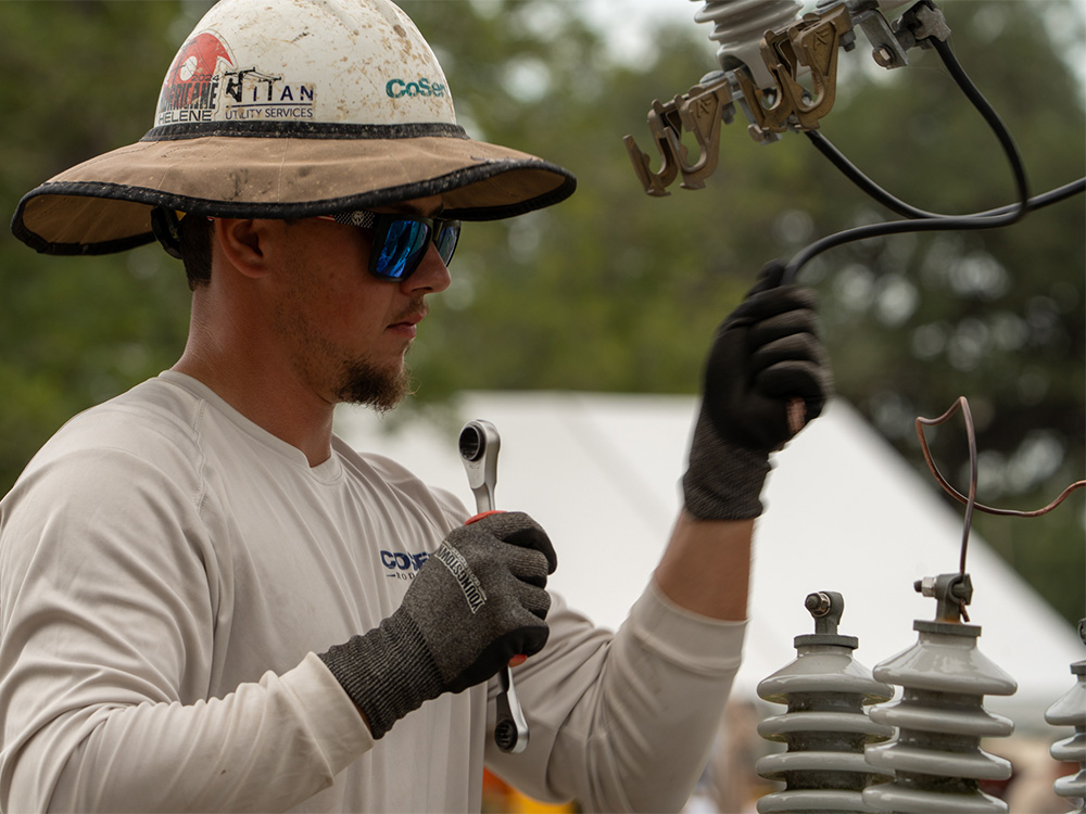 CoServ Lineman Kenny Beutter competes in the Apprentice 3 Phase Transformer Bank competition during the 2025 Texas Lineman Rodeo.