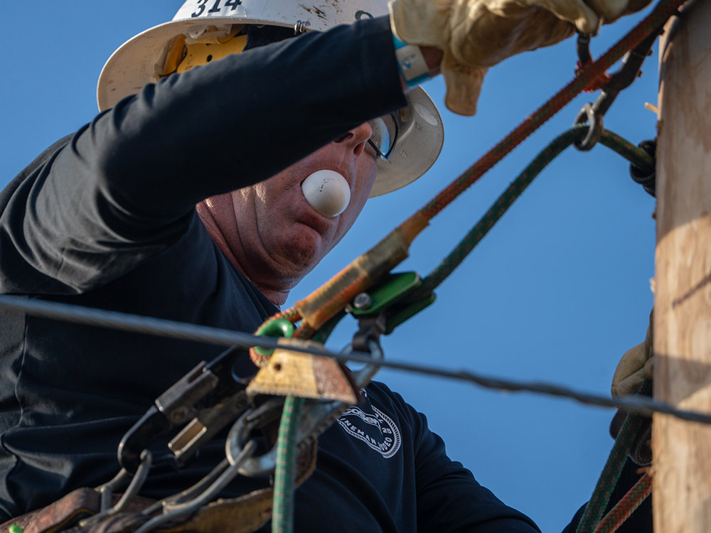 CoServ Journeyman Chris Hammonds holds an egg in his mouth as he competes in the Egg Race. 