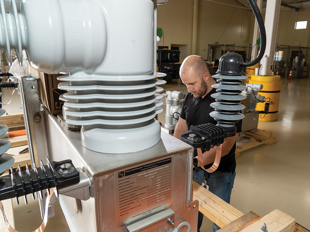 CoServ Distribution Automation Engineer Brendon Bailey runs a test on an IntelliRupter® PulseCloser® Fault Interrupter before it goes out into the field.