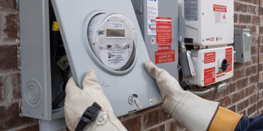 Brock Squier performing a meter check on a solar set up at a residence in Aubrey, Texas.
